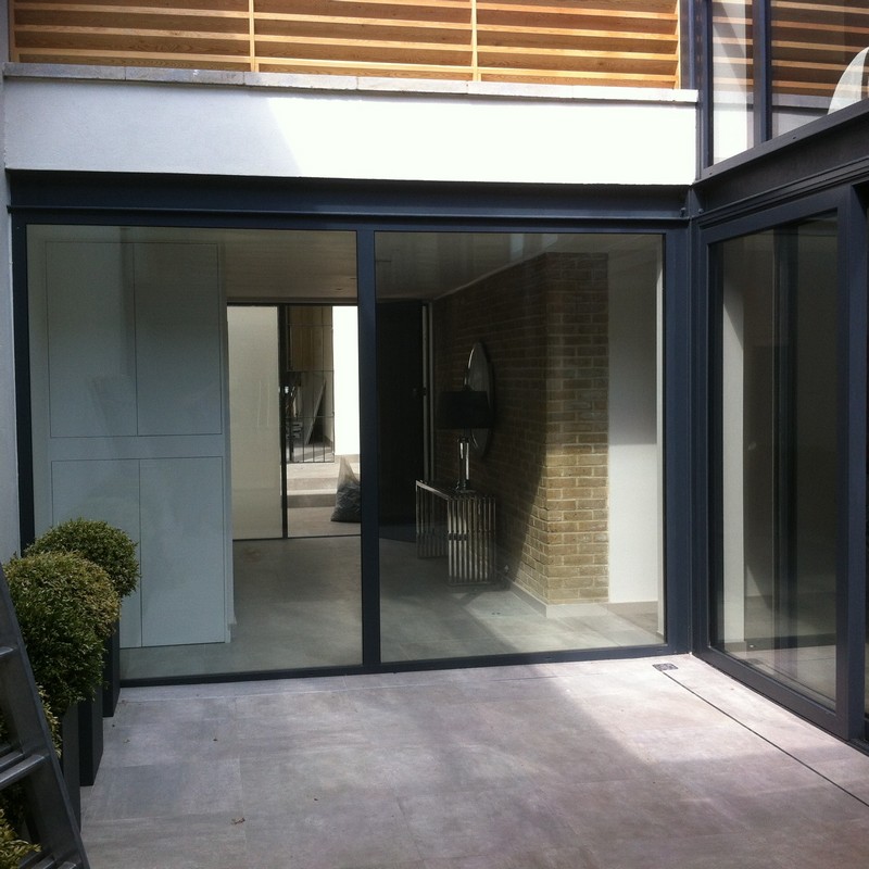 Floor-to-ceiling sliding doors opening to courtyard in Hammersmith