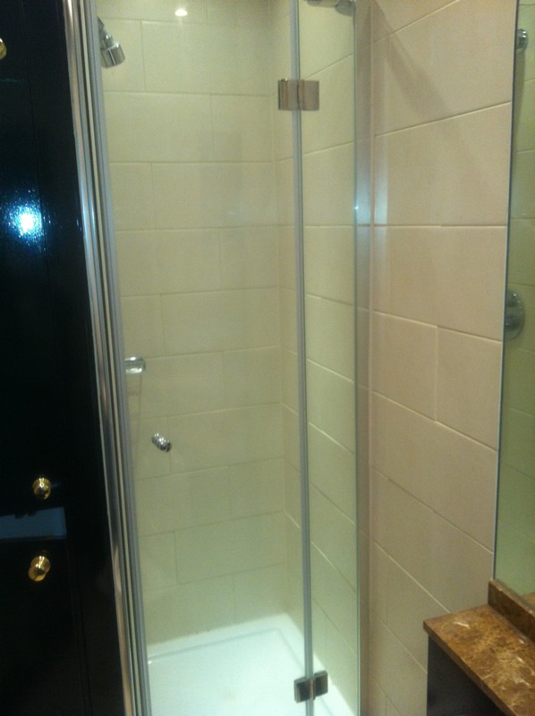 Frameless glass shower enclosure with chrome fittings in Hammersmith